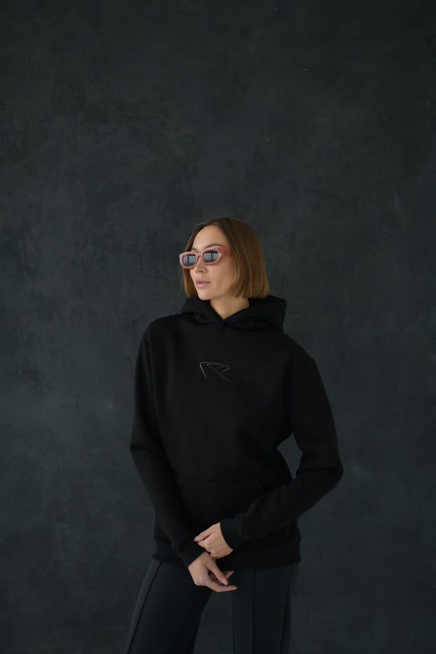 Female model wearing All Black Everything Hoodie